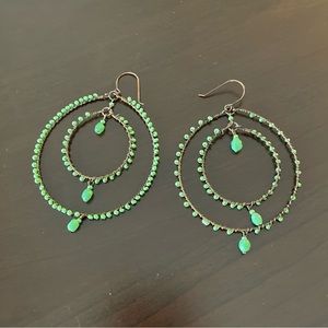 Large front facing double hoop earrings with turquoise colored beading.